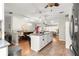 Open concept kitchen features a marble island with seating and views of the dining and living areas at 8874 Sw 95Th St # E, Ocala, FL 34481
