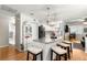 Bright, open kitchen boasts a marble island with seating, updated appliances, and modern lighting fixtures at 8874 Sw 95Th St # E, Ocala, FL 34481