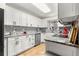 Updated kitchen features white cabinets, stainless steel appliances, granite countertops and a farmhouse sink at 8874 Sw 95Th St # E, Ocala, FL 34481