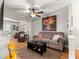 Cozy living room with comfortable seating, a ceiling fan, and a large floral painting on the wall at 8874 Sw 95Th St # E, Ocala, FL 34481