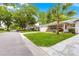 Street view of homes with lush lawns, mature trees, and well-maintained landscaping at 8874 Sw 95Th St # E, Ocala, FL 34481