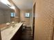 Bathroom with patterned wallpaper, commode, and single vanity with natural light coming from a window at 8901 Sw 103Rd Ln, Ocala, FL 34481