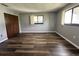 Bedroom with two windows and wood-look vinyl flooring, offering plenty of natural light and closet space at 8901 Sw 103Rd Ln, Ocala, FL 34481