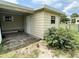 View of the home's exterior featuring a covered side area, a door, and a storage shed at 8901 Sw 103Rd Ln, Ocala, FL 34481