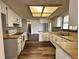 Functional kitchen with white cabinets, sleek countertops, and hardwood floors at 8901 Sw 103Rd Ln, Ocala, FL 34481