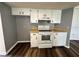 Well-lit kitchen featuring an updated oven, white cabinets, and modern flooring at 8901 Sw 103Rd Ln, Ocala, FL 34481