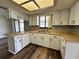 Updated kitchen showcasing white cabinets, ample counter space, and modern flooring at 8901 Sw 103Rd Ln, Ocala, FL 34481