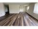 Open-plan living room with updated floors and natural light at 8901 Sw 103Rd Ln, Ocala, FL 34481