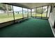Enclosed sunroom with green carpeting and large windows providing plenty of natural light and outdoor views at 8901 Sw 103Rd Ln, Ocala, FL 34481