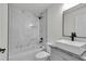 Modern bathroom with a tub-shower combination with white marble-patterned tile and black fixtures at 904 Nw 67Th St, Ocala, FL 34474