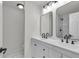 Bright bathroom featuring a double sink vanity with matte black faucets and framed mirrors at 904 Nw 67Th St, Ocala, FL 34474