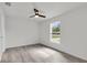 Bright bedroom with wood-look laminate flooring and a ceiling fan at 904 Nw 67Th St, Ocala, FL 34474