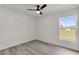 Bright bedroom with wood-look laminate flooring and a large window with a clear view at 904 Nw 67Th St, Ocala, FL 34474