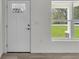 Bright entryway featuring a front door with glass and a view of the outdoors through a window at 904 Nw 67Th St, Ocala, FL 34474