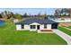 Charming single-story home with a well-manicured lawn, black garage, and a welcoming front entrance at 904 Nw 67Th St, Ocala, FL 34474