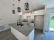 Stylish kitchen island with granite countertops, pendant lights, and a modern faucet at 904 Nw 67Th St, Ocala, FL 34474
