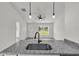 Open kitchen view highlighting the granite countertops, modern faucet, and layout connected to the living area at 904 Nw 67Th St, Ocala, FL 34474
