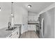 Bright kitchen featuring stainless steel appliances, granite counters, and white cabinets at 904 Nw 67Th St, Ocala, FL 34474