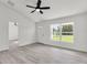 Inviting living room with large windows and wood-style flooring, showcasing natural light and ample space at 904 Nw 67Th St, Ocala, FL 34474