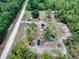 Expansive aerial view of a rural property featuring a house with solar panels, fenced yard and mature trees at 9325 Sw 125Th Court Rd, Dunnellon, FL 34432