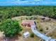 Sprawling property featuring a single-story home with white fencing, lush landscaping and long driveway at 9325 Sw 125Th Court Rd, Dunnellon, FL 34432
