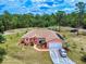 Charming single-story home with a well-manicured front yard, white perimeter fence and long driveway at 9325 Sw 125Th Court Rd, Dunnellon, FL 34432