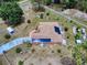 Aerial view of a home showcasing solar panels on the roof, surrounded by a well-maintained, fenced yard at 9325 Sw 125Th Court Rd, Dunnellon, FL 34432