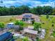Wide shot featuring home with solar panels, lush backyard, and white perimeter fencing creating a private oasis at 9325 Sw 125Th Court Rd, Dunnellon, FL 34432