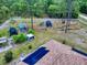 Overview of the backyard with gardening structures and solar panels on the roof for energy efficiency at 9325 Sw 125Th Court Rd, Dunnellon, FL 34432