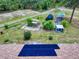 View highlighting the backyard's potential, featuring garden beds and solar panels on the home's roof at 9325 Sw 125Th Court Rd, Dunnellon, FL 34432