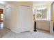 Bright bathroom featuring tile flooring, a vanity with sink, and ample closet space at 9325 Sw 125Th Court Rd, Dunnellon, FL 34432