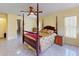 Bedroom featuring tile flooring, ceiling fan, a large window and glass paneled exterior door at 9325 Sw 125Th Court Rd, Dunnellon, FL 34432