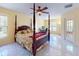 Bedroom featuring tile flooring, ceiling fan, a large window and glass paneled exterior door at 9325 Sw 125Th Court Rd, Dunnellon, FL 34432