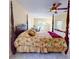 Spacious bedroom with tile flooring, ceiling fan, a large window and glass paneled exterior door at 9325 Sw 125Th Court Rd, Dunnellon, FL 34432
