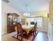 Formal dining room with elegant chandelier, wood table and chairs, and a china cabinet at 9325 Sw 125Th Court Rd, Dunnellon, FL 34432
