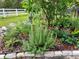 Charming garden with flourishing herbs and plants, surrounded by mulch and pavers at 9325 Sw 125Th Court Rd, Dunnellon, FL 34432