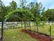View of a garden space with greenery and trellises, adding unique charm to the exterior of the property at 9325 Sw 125Th Court Rd, Dunnellon, FL 34432
