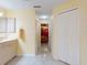 Hallway featuring tile flooring, neutral paint, access to bedroom and bath, and closet storage at 9325 Sw 125Th Court Rd, Dunnellon, FL 34432