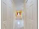 Hallway leading to a bathroom with bathtub and glass enclosed shower stall at 9325 Sw 125Th Court Rd, Dunnellon, FL 34432