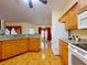 Bright kitchen with granite countertops, wood cabinetry, and tile flooring at 9325 Sw 125Th Court Rd, Dunnellon, FL 34432