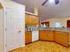 Charming kitchen features wood cabinets, granite countertops, and decorative tile floors at 9325 Sw 125Th Court Rd, Dunnellon, FL 34432