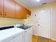 Functional laundry room with modern washer and dryer, and ample storage space at 9325 Sw 125Th Court Rd, Dunnellon, FL 34432