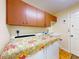 Spacious laundry room with ample cabinet storage and a utility sink at 9325 Sw 125Th Court Rd, Dunnellon, FL 34432