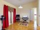 Bright living room with tile floors, red curtains, and an electronic keyboard for music enthusiasts at 9325 Sw 125Th Court Rd, Dunnellon, FL 34432