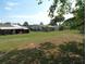 Large grass covered backyard with some bare areas, surrounded by chain link fencing at 9430 Sw 102Nd Pl, Ocala, FL 34481