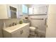 Bright bathroom features modern vanity with storage, toilet, mirror, and cabinets at 9430 Sw 102Nd Pl, Ocala, FL 34481