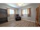Comfortable bedroom featuring wood-look flooring, natural light, and neutral tones at 9430 Sw 102Nd Pl, Ocala, FL 34481