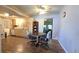 Cozy dining area with wood floors, adjacent to kitchen and bright sliding glass door to the backyard at 9430 Sw 102Nd Pl, Ocala, FL 34481