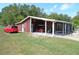 Exterior view of the covered area, with a golf cart parked inside at 9430 Sw 102Nd Pl, Ocala, FL 34481