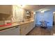 Well-lit kitchen with a double sink, wood-look floors, and adjacent dining space at 9430 Sw 102Nd Pl, Ocala, FL 34481